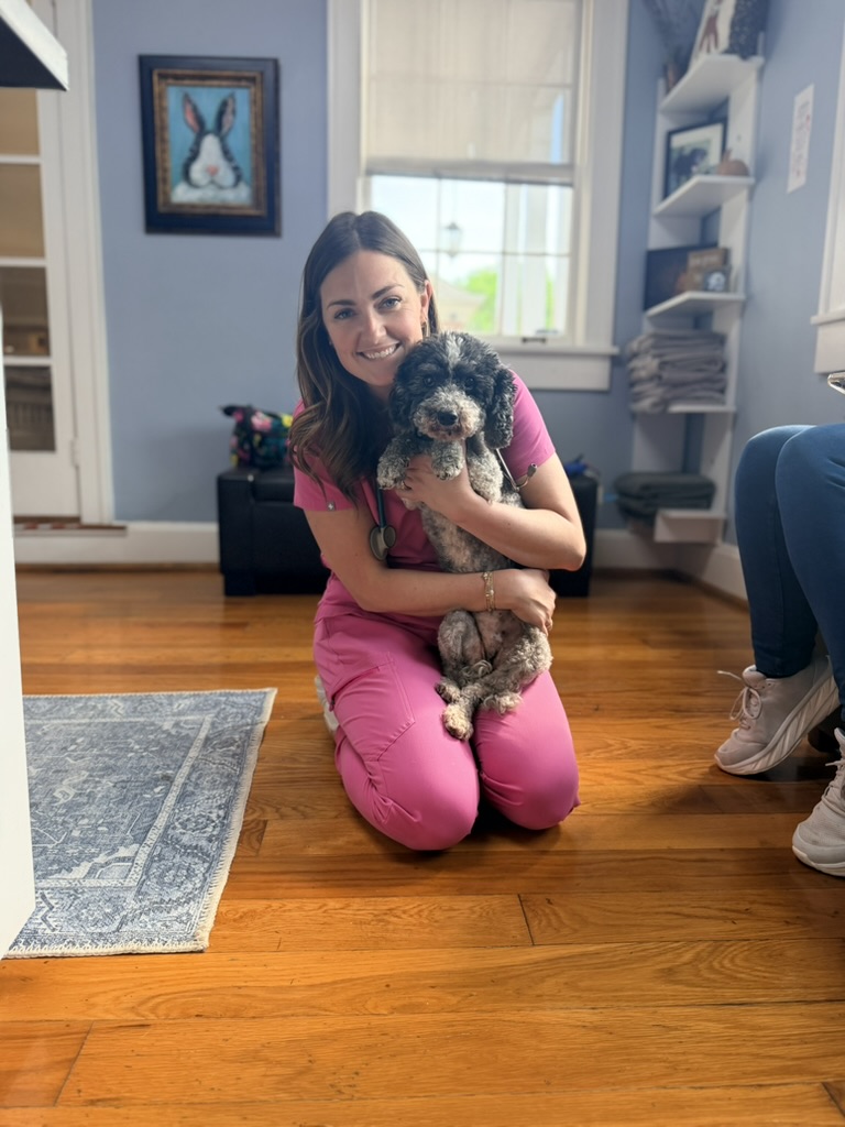 Dr. Molly Brinkmann holding a poodle patient
